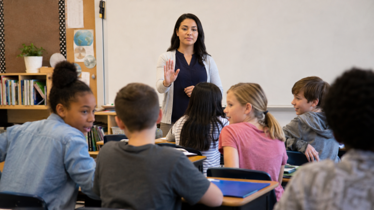 Teacher using a calm attention signal while students are talking